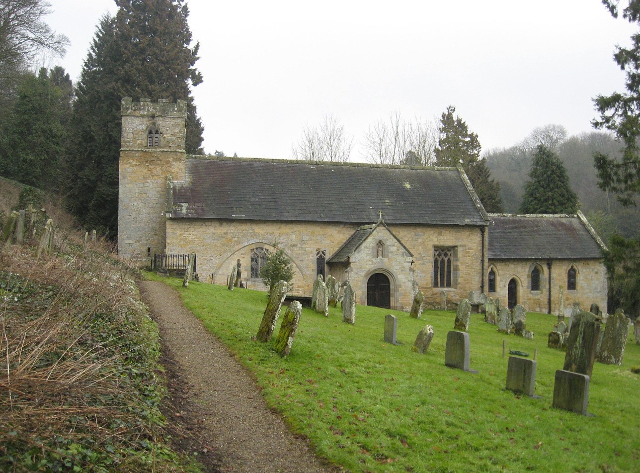 St Mary's Church, Ebberston, a stone church with a square tower in its churchyard